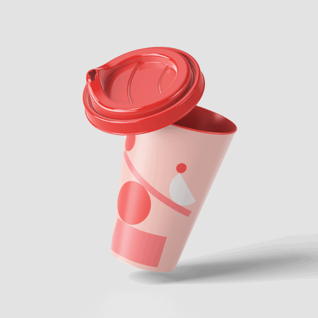 A red and pink coffee cup with a lid and pictures of balanced shapes on the side
